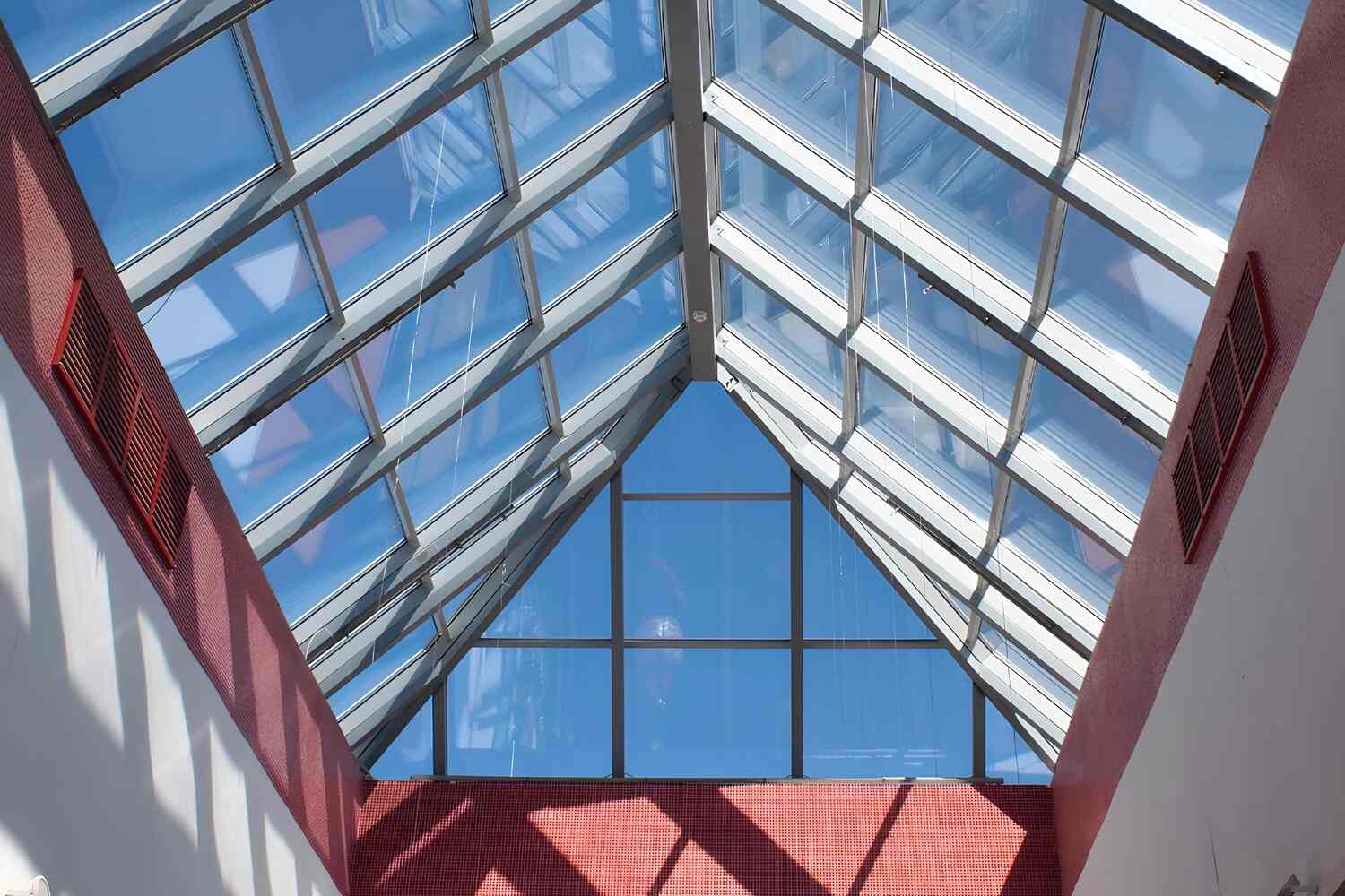 Window film applied to skylight glass roofing to block heat and UV rays while maintaining clear daylight views