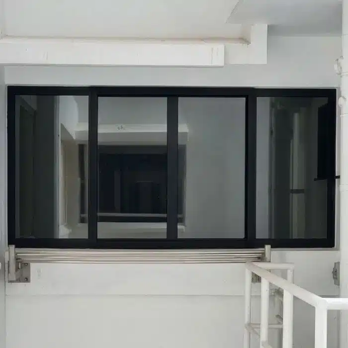 One-way mirror window film providing daytime privacy, exterior view of kitchen yard with installed reflective glass film blocking visibility from outside.